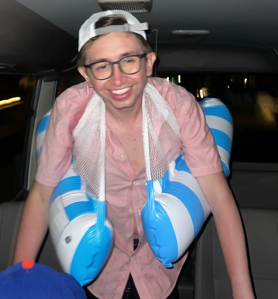 Lorenzo in a car surrounded by oversized blue-and-white inflatables